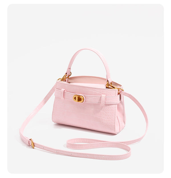 Small structured crocodile-embossed top-handle bag with gold-tone turn-lock closure and detachable shoulder strap, detail