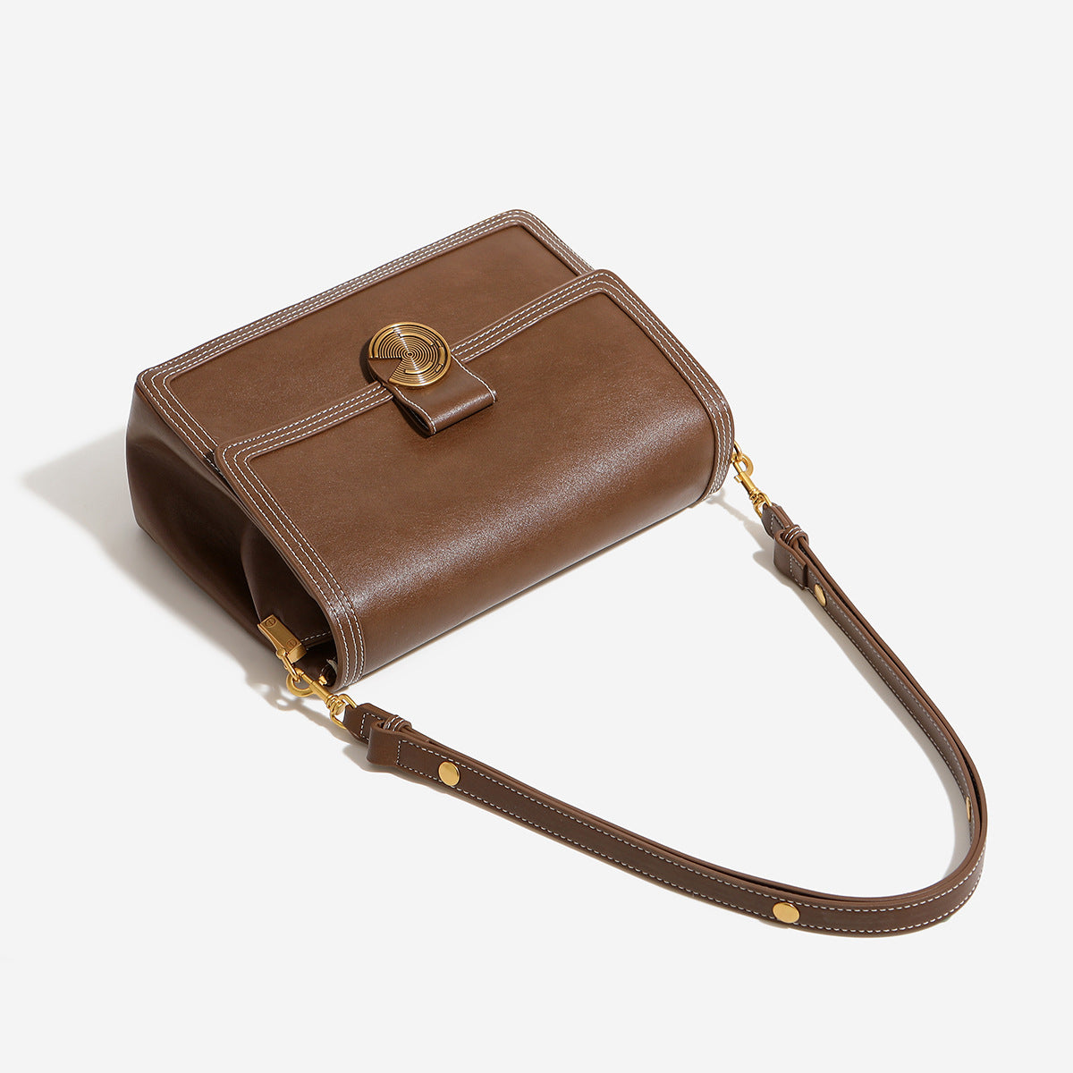 Structured flap shoulder bag with gold-tone circular turn-lock closure, white contrast stitching, and adjustable strap