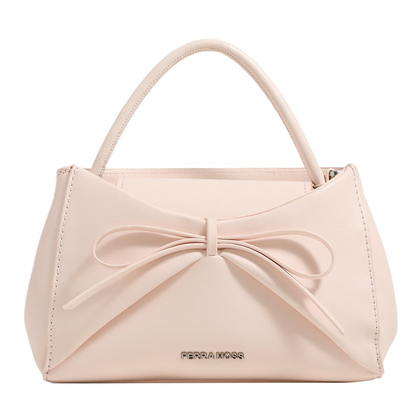 Structured mini trapezoid top-handle crossbody bag with sculpted bow front detail, smooth matte finish, silver-tone hardware