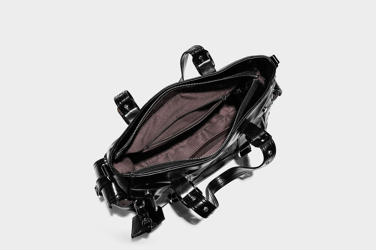 Glossy structured black tote shoulder bag with silver buckle hardware, zip pockets, dual top handles, and detachable, detail