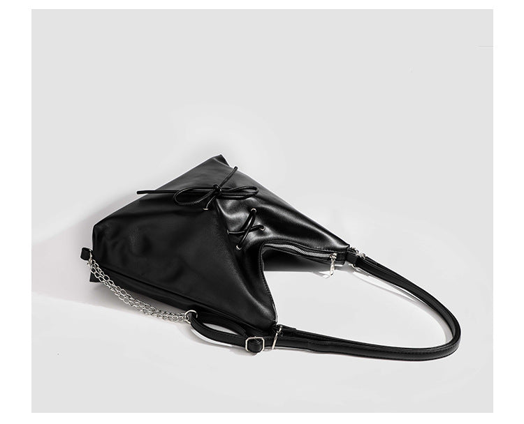 Glossy leather-look hobo shoulder bag with front bow lacing detail and silver-tone chain strap, detail view 23