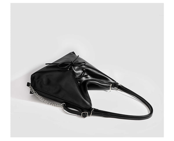 Glossy leather-look hobo shoulder bag with front bow lacing detail and silver-tone chain strap, detail view 23