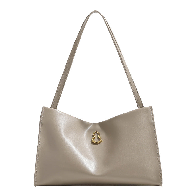 Smooth leather-look slouchy trapezoid shoulder tote with gold-tone gourd clasp hardware and long slim straps, detail view 5