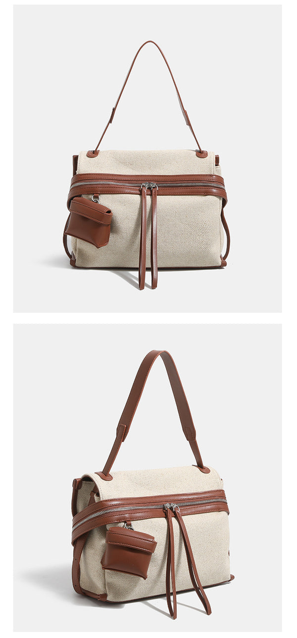 Off-white woven cotton-linen shoulder bag with brown leather-look trim, dual zip closure, long zipper pulls, front exterior