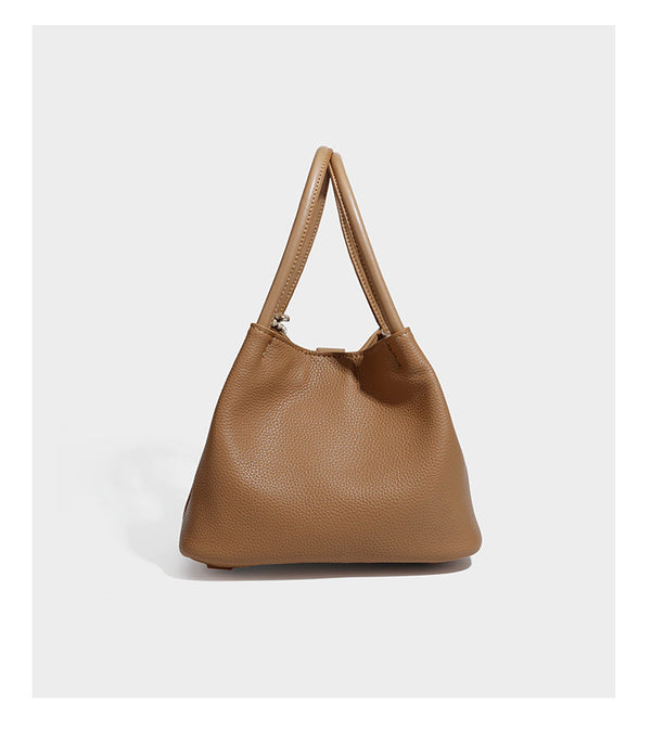 Pebbled leather-look bucket tote bag with rolled double handles, drawstring closure, braided cord charm, and detachable