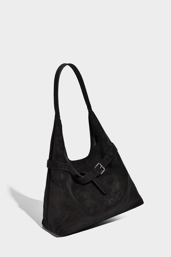 Slouchy oversized shoulder tote bag with matte textured finish, wrap-around buckle strap, and detachable front zip pouch