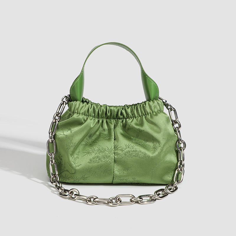 Small ruched satin-finish cloud bag with elasticized drawstring top, short top handle, and chunky silver-tone chain strap