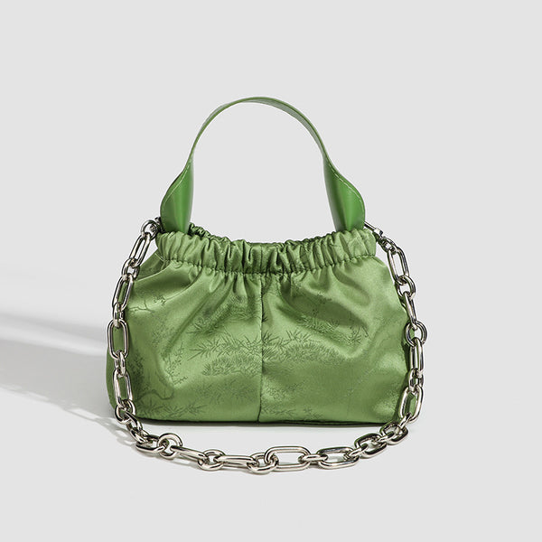 Small ruched satin-finish cloud bag with elasticized drawstring top, short top handle, and chunky silver-tone chain strap