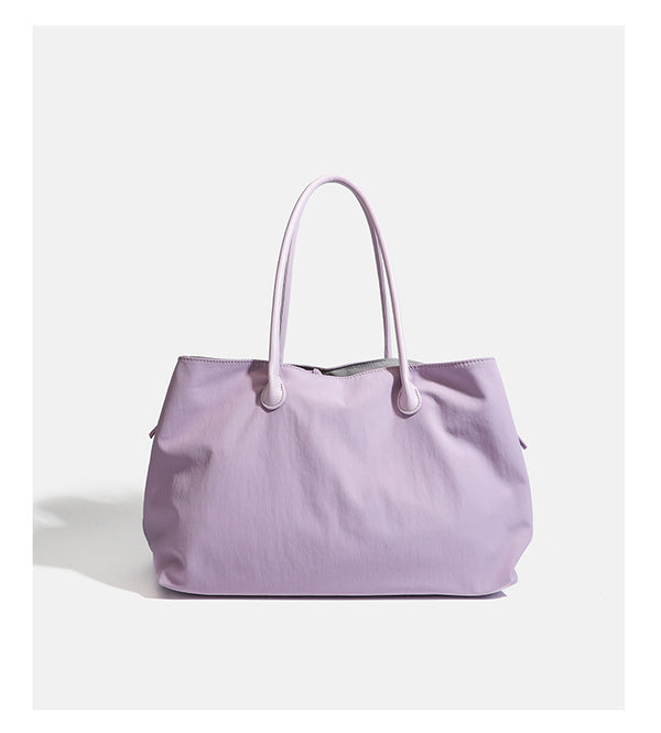 Large soft nylon tote bag with long double handles and zippered top in lavender, detail view 11