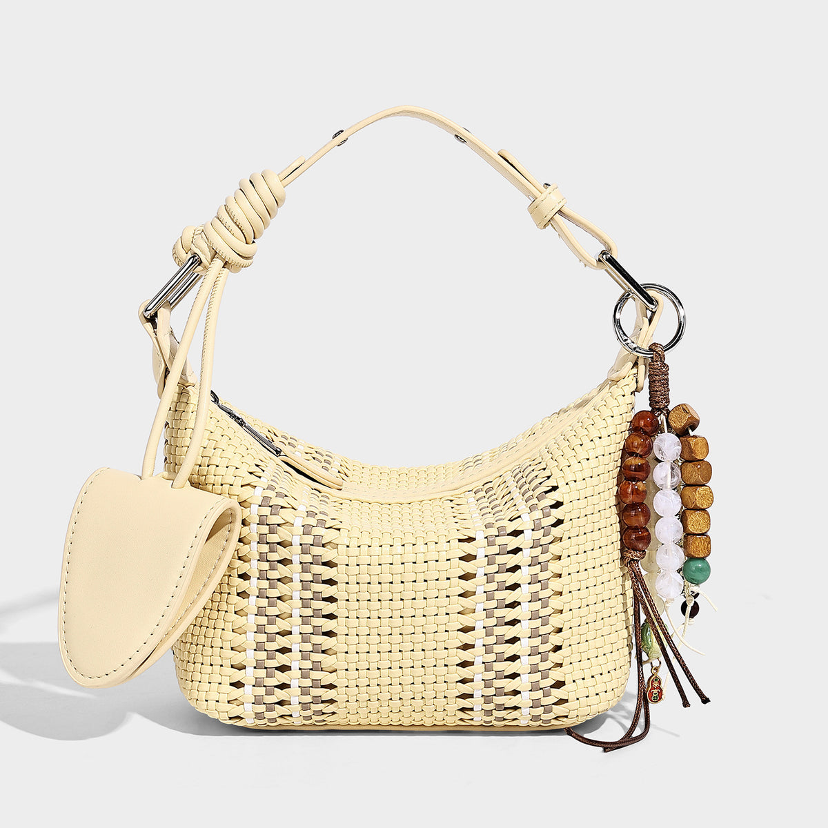 Small woven crescent shoulder bag with leather-look trim, zip closure, silver-tone ring hardware, and beaded tassel charm