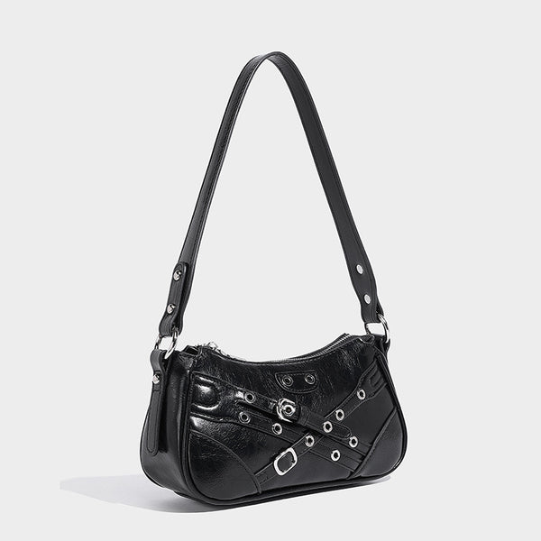 Compact moto-inspired shoulder bag with crisscross grommet strap detail, glossy textured finish, and adjustable crossbody