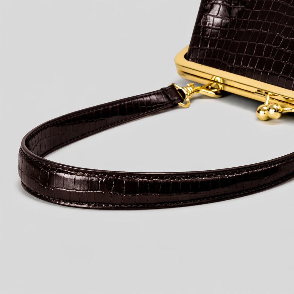 Trapezoid kiss-lock frame shoulder bag with gold-tone hardware and slim adjustable strap, detail view 18
