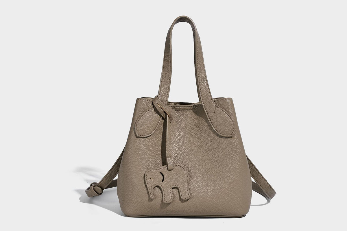 Compact pebbled bucket tote bag with elephant charm, twin top handles, and detachable crossbody strap, detail view 34