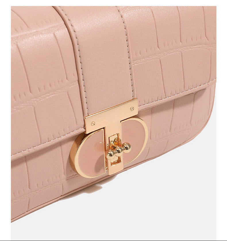 Small crocodile-embossed flap crossbody bag with circular gold turn-lock closure and chain strap, detail view 11