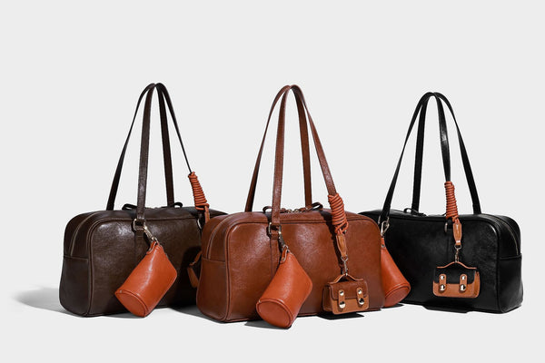 Strukturierte Boston-Schultertasche in glänzender Lederoptik mit zwei langen Trageriemen, Reißverschluss oben, goldfarbenen Beschlägen und zwei