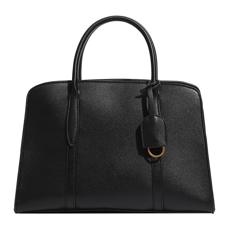 Structured trapezoid Boston satchel bag with dual top handles, gold-tone lock charm, and top zip closure, detail view 5