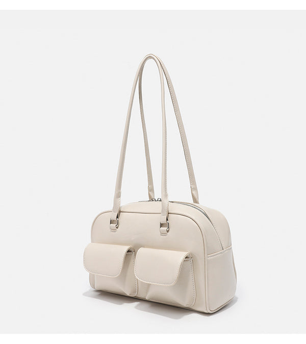 Structured glossy leather-look bowling shoulder bag with two front flap pockets, top zip closure, and long double shoulder
