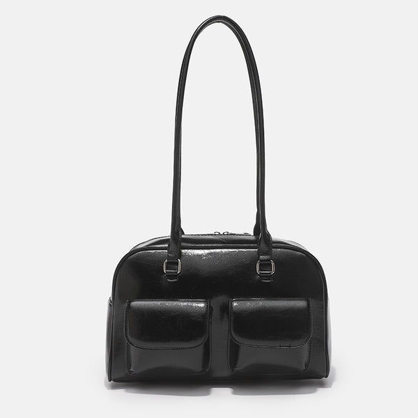 Structured glossy leather-look bowling shoulder bag with two front flap pockets, top zip closure, and long double shoulder