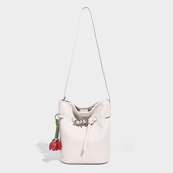 Small pebbled leather-look bucket bag with front drawstring toggle hardware and long adjustable shoulder strap, detail view 3