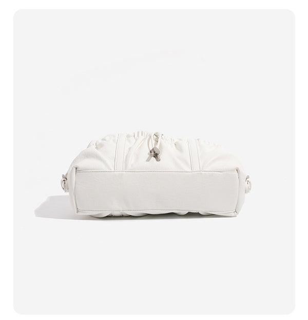 Ivory leather-look shoulder bag with ruched front panels, drawstring toggle, silver-tone hardware, and dual top handles