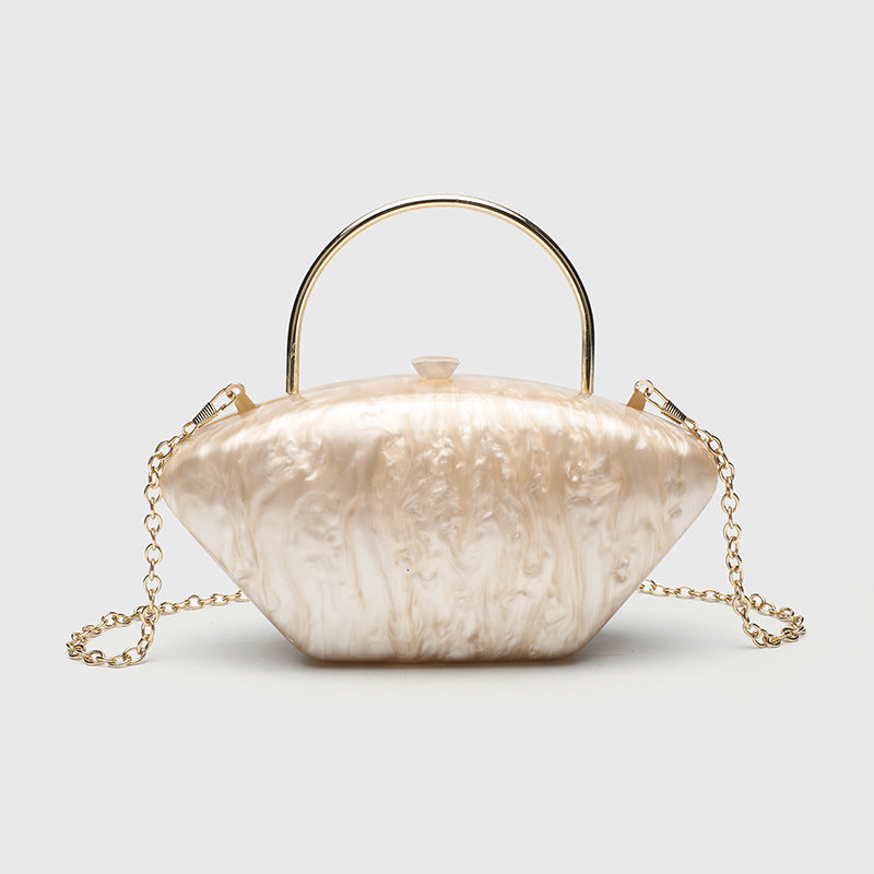 Shell-shaped pearlescent top-handle clutch bag with arched gold-tone metal handle and gold chain strap, detail view 10