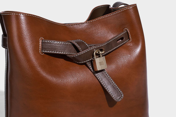 Glänzende Beuteltasche in Lederoptik mit Riemendetail mit Vorhängeschloss und verstellbarem langem Riemen, Detailansicht 16