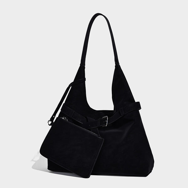 Slouchy oversized shoulder tote bag with matte textured finish, wrap-around buckle strap, and detachable front zip pouch