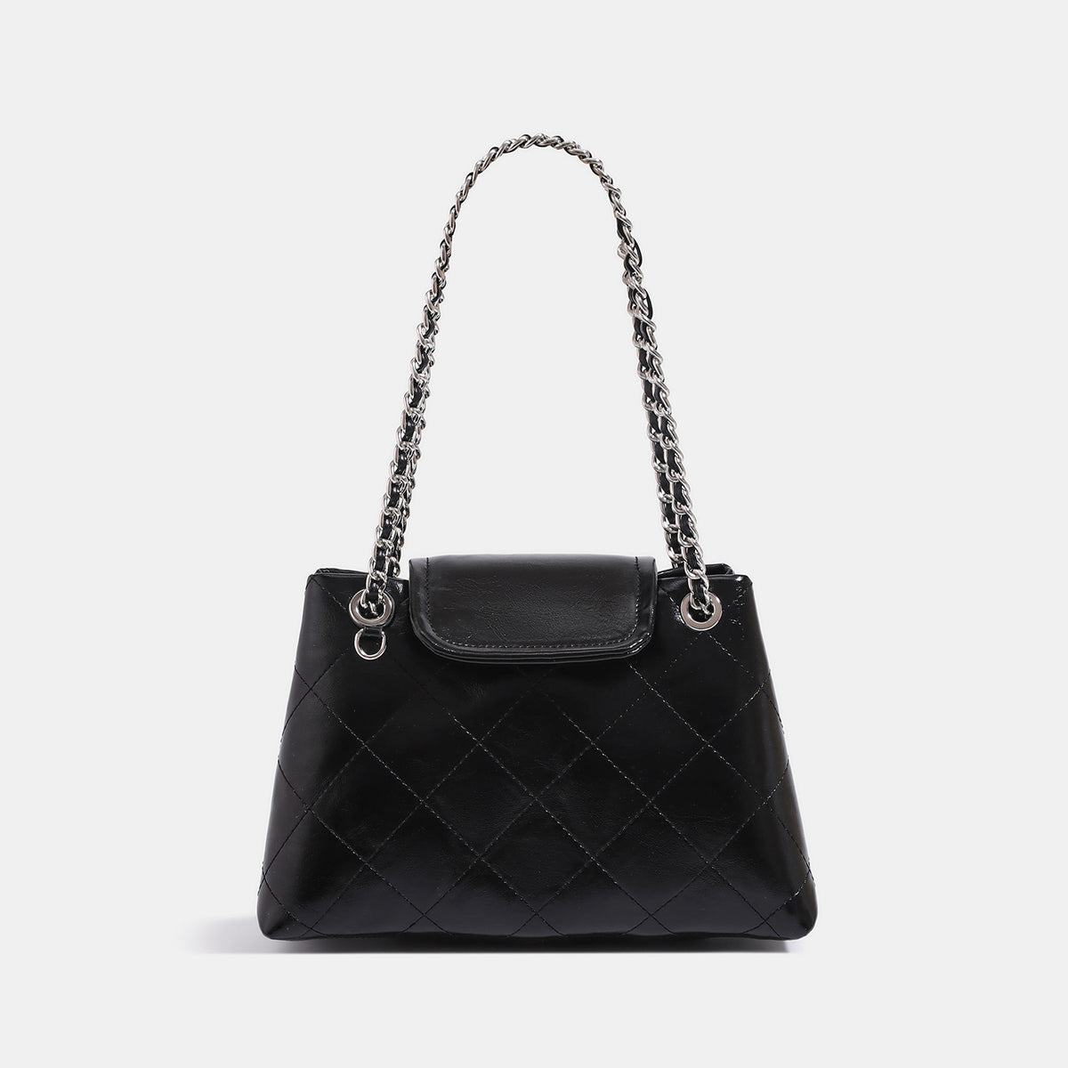 Quilted trapezoid shoulder bag with chain straps, flap closure, and ring hardware, detail view 6