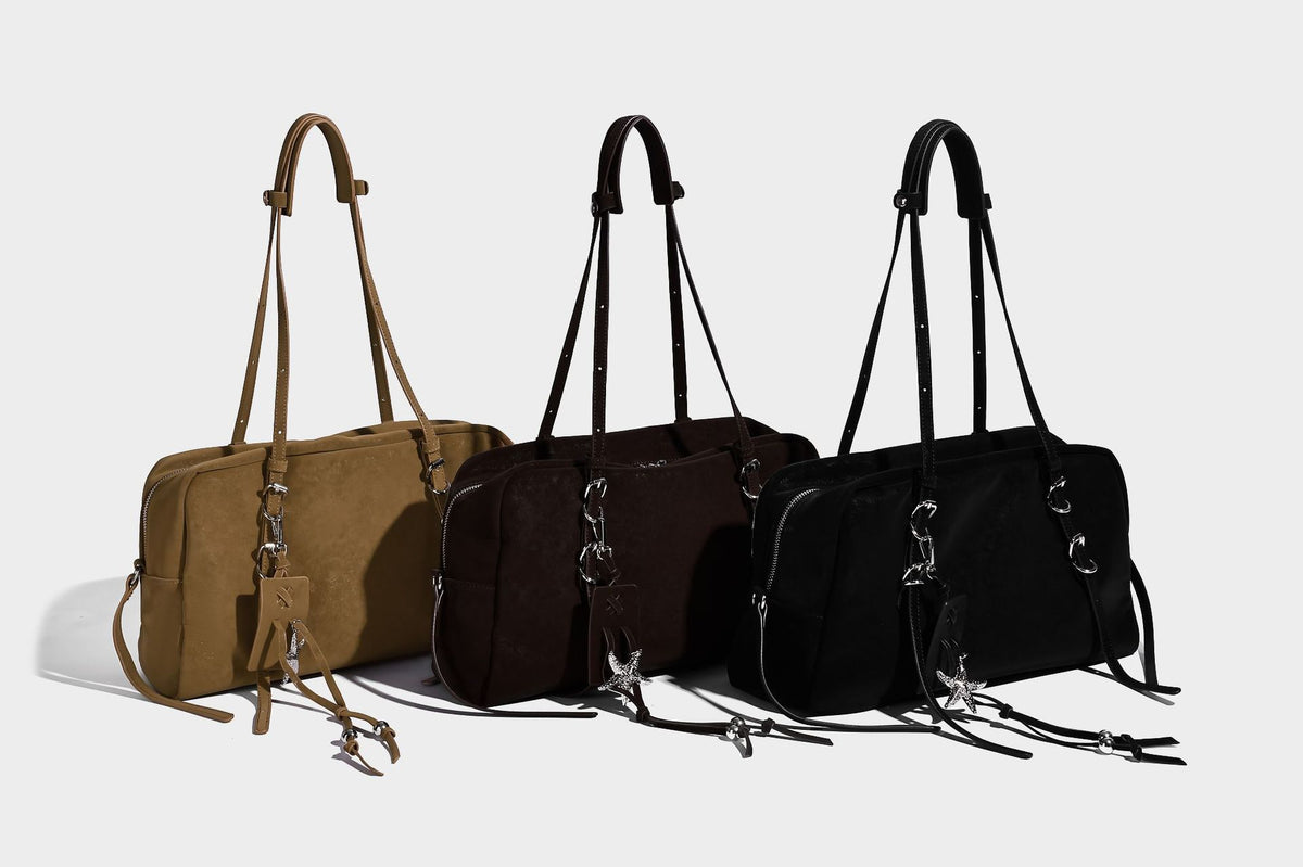 Structured rectangular matte suede-like shoulder bag with silver-tone hardware, zip closure, double top handles, and, detail