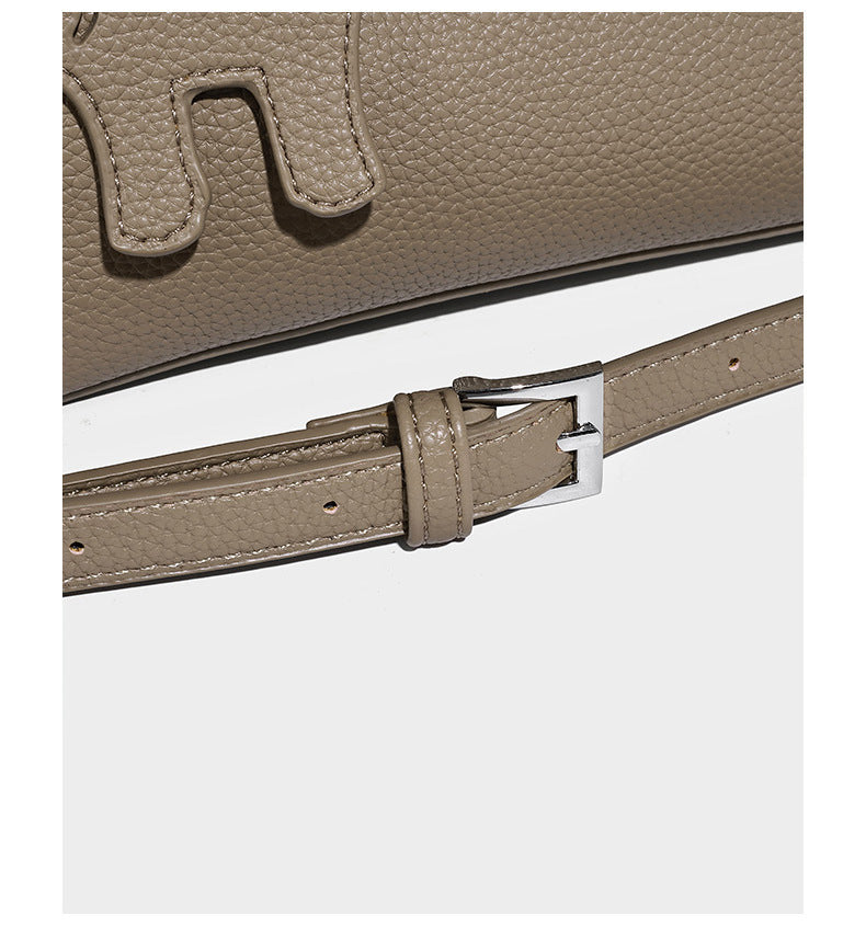 Compact pebbled bucket tote bag with elephant charm, twin top handles, and detachable crossbody strap, detail view 12