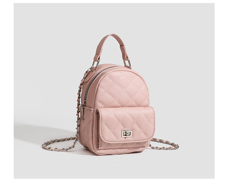 Compact diamond-quilted mini backpack handbag with silver-tone chain straps and turn-lock front pocket, detail view 16