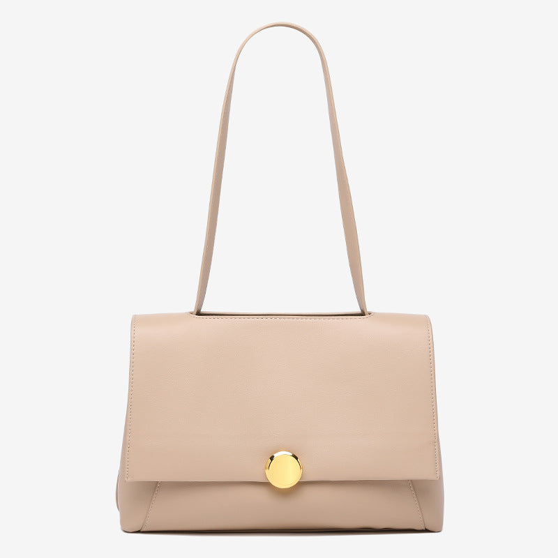 Structured flap shoulder bag with round gold-tone clasp and long flat strap in smooth matte leather-look finish, detail view