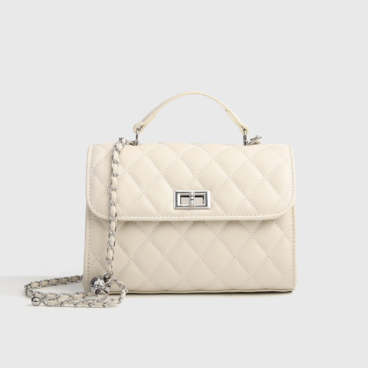 Small structured diamond-quilted flap satchel bag with silver-tone chain strap and turn-lock closure, detail view 7