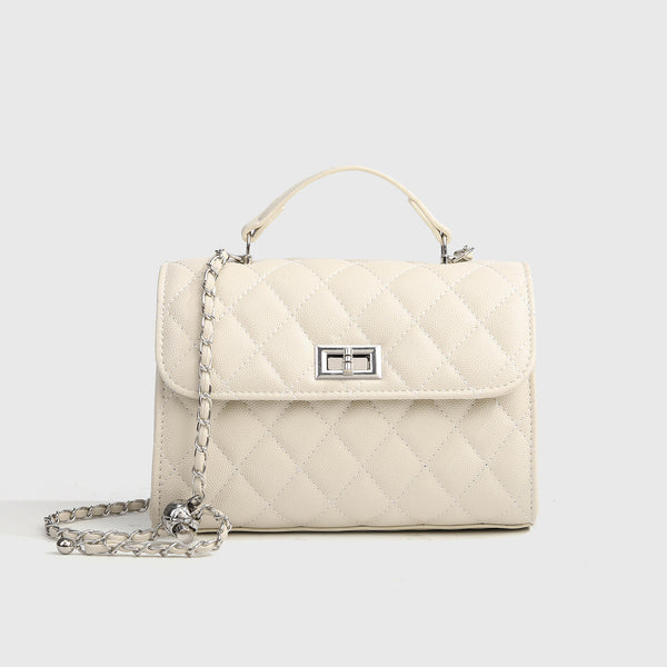 Small structured diamond-quilted flap satchel bag with silver-tone chain strap and turn-lock closure, detail view 7