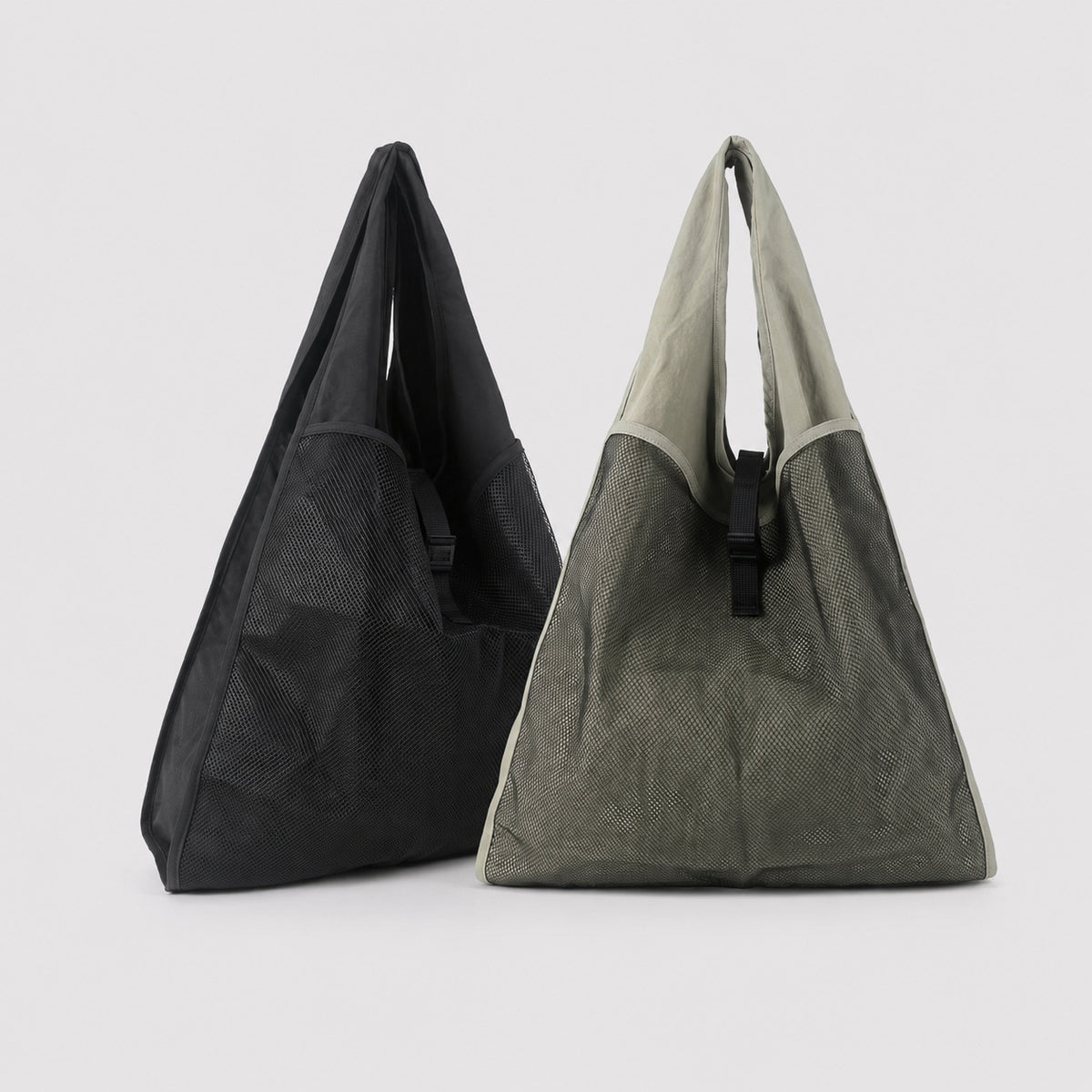 Oversized triangular mesh tote bag with matte olive-khaki fabric straps and trim, dark open-weave mesh body, matte black