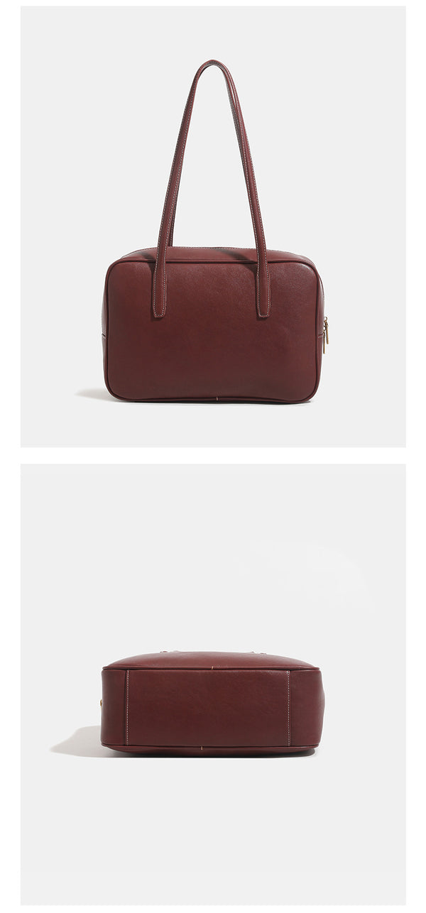 Structured rectangular leather-look shoulder bag with top zip, tassel and resin ring charm, and contrast topstitching, detail