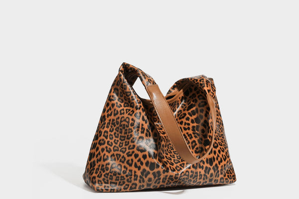 Glossy leopard-print slouchy shoulder bag with long strap and detachable tan zip pouch, detail view 29