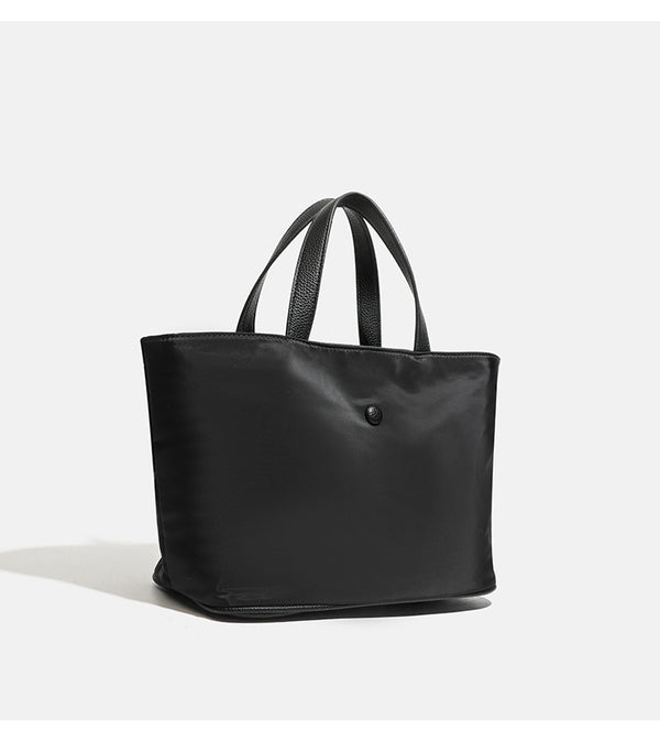 Structured lightweight nylon tote bag with textured double top handles and snap-button front detail, detail view 14