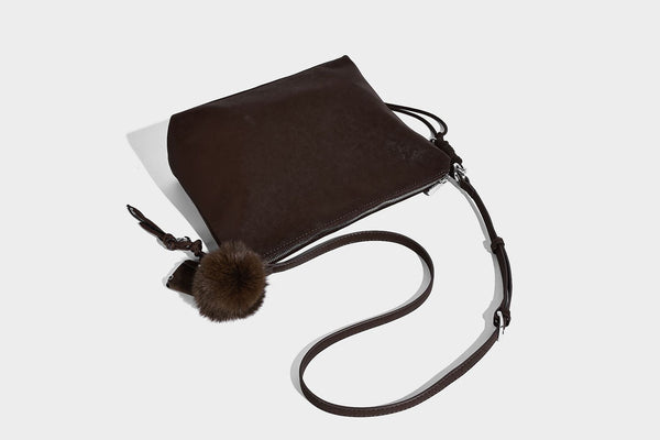 Slouchy matte-finish hobo shoulder bag with tassel cords, silver-tone hardware, and faux-fur pom charm, detail view 17