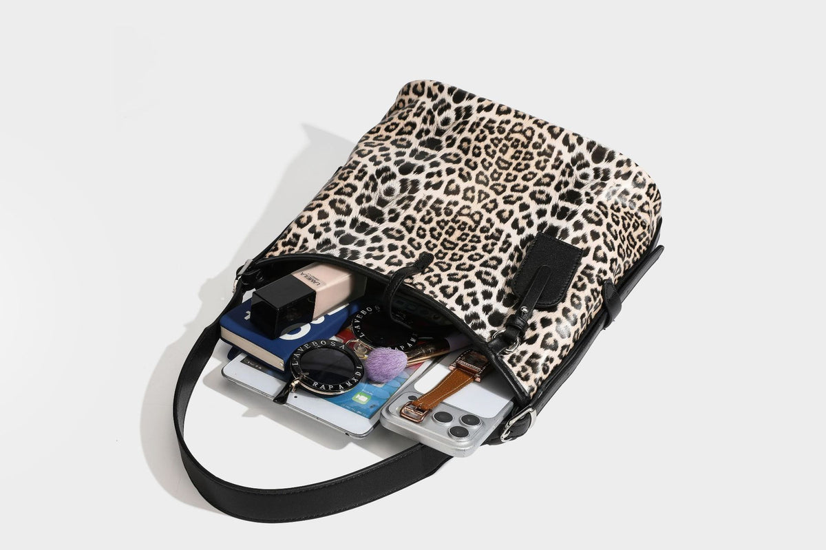 Slouchy leopard print shoulder hobo bag with black leather-look trim, tie-top closure, and single long strap, detail view 39