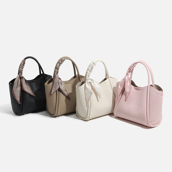Pebbled leather-look bucket tote bag with scarf-wrapped top handle and gold-tone hardware, detail view 4