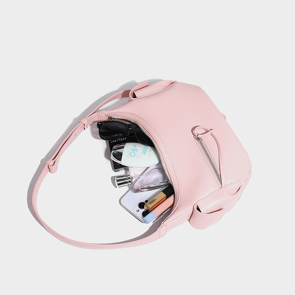 Smooth leather-look crescent shoulder bag with front zip pocket, side flap pockets, adjustable strap, and silver-tone, detail