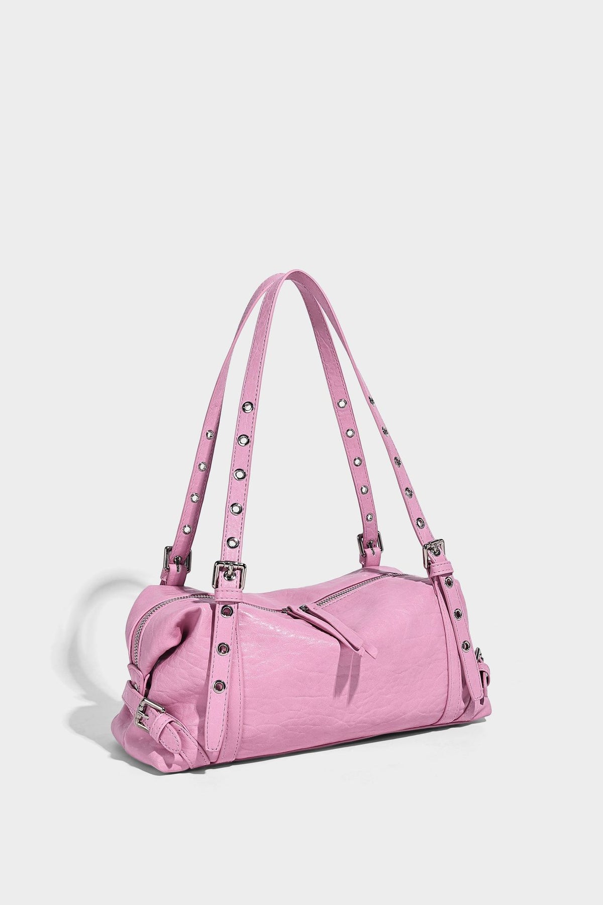 Pale yellow leather-look barrel bag with silver grommet-studded shoulder straps, top zip closure, and pink tulip floral