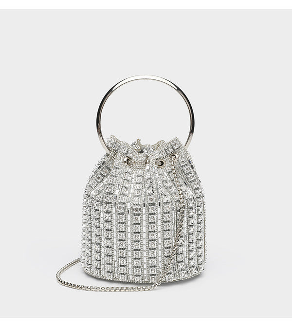 Mini crystal rhinestone bucket bag with circular ring top handle, drawstring closure, and silver chain shoulder strap, detail