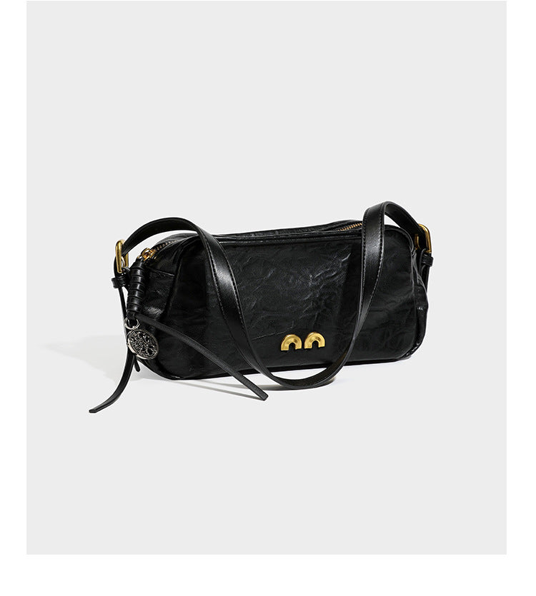 Compact black crinkled leather-look baguette shoulder bag with gold-tone arch hardware and adjustable strap, detail view 15