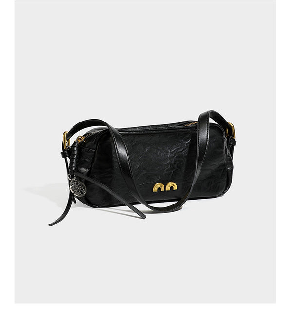 Compact black crinkled leather-look baguette shoulder bag with gold-tone arch hardware and adjustable strap, detail view 15