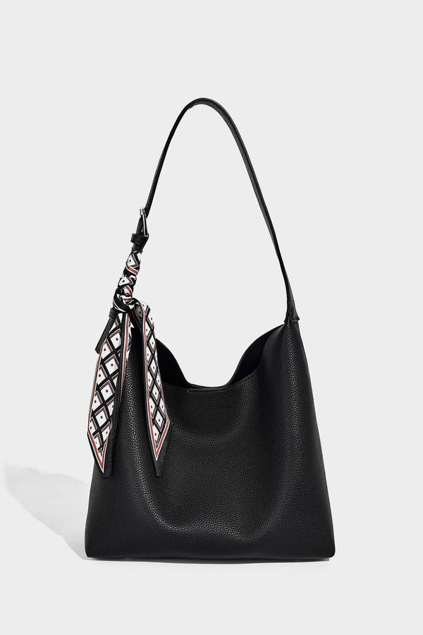Soft slouchy hobo shoulder bag in pebbled matte finish with slim strap, silver-tone ring hardware, and knotted printed scarf