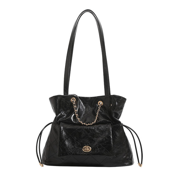 Black glossy diamond-quilted bucket tote bag with gold-tone chain accent, turn-lock front flap pocket, drawstring side ties
