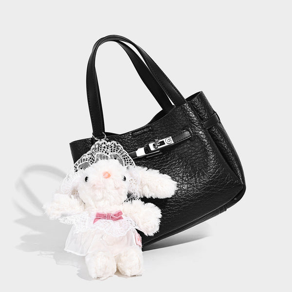 Small structured pebbled bucket tote with double top handles, silver turn-lock hardware, and detachable shoulder strap