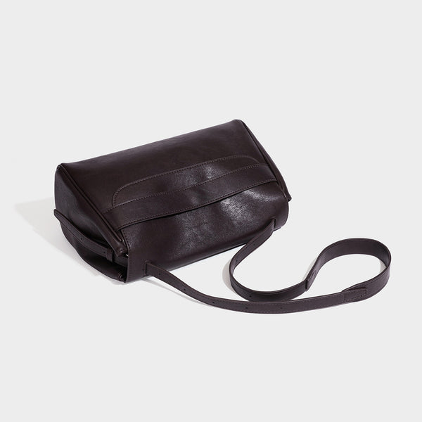 Structured rectangular flap shoulder bag in dark brown leather-look finish with long single strap and layered front panel